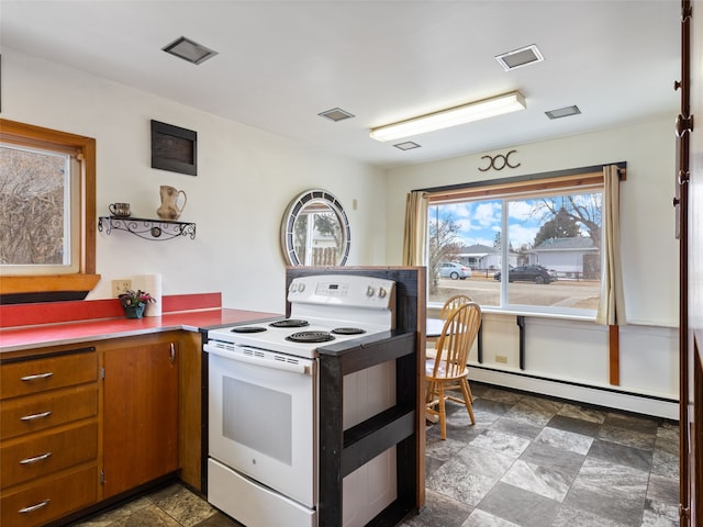 kitchen featuring visible vents, baseboard heating, brown cabinets, stone finish flooring, and white electric range oven