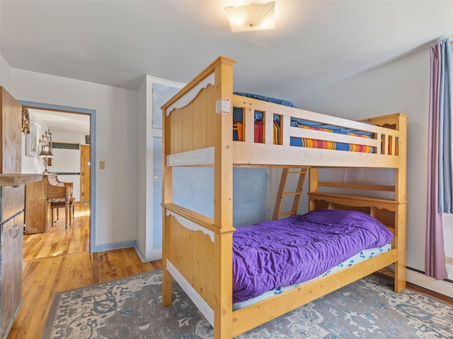 bedroom featuring baseboards and wood finished floors