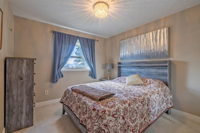 bedroom with a textured ceiling, carpet, and baseboards