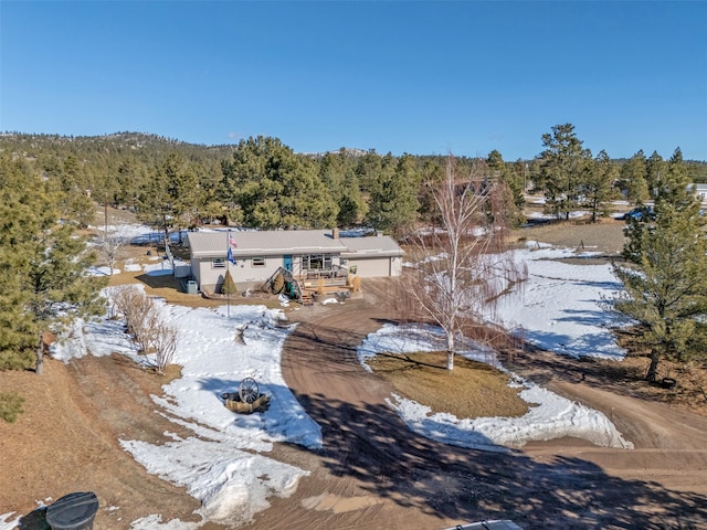 drone / aerial view featuring a wooded view