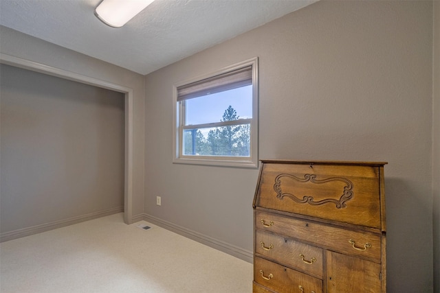 carpeted bedroom with visible vents and baseboards