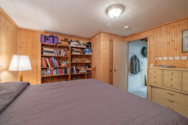 bedroom featuring wooden walls