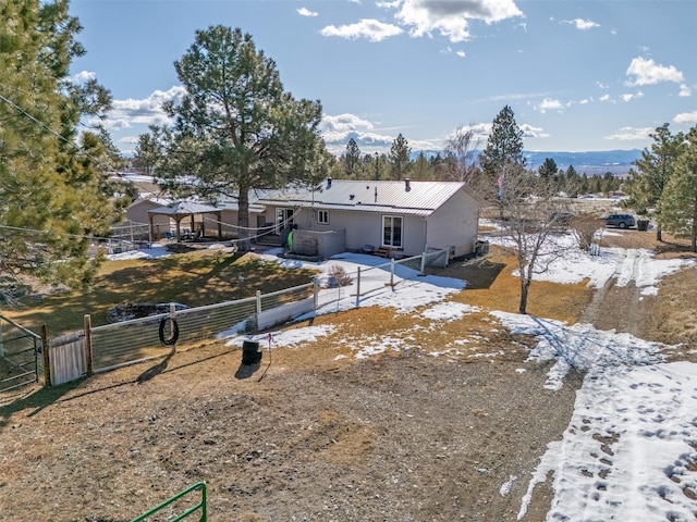 view of front of house with fence and metal roof