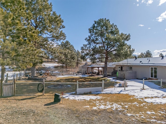 yard covered in snow featuring fence and a patio