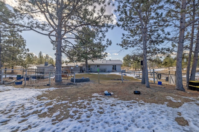 yard covered in snow featuring fence