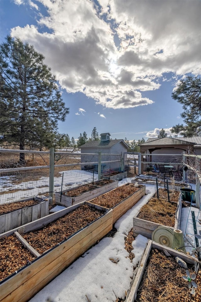 view of yard featuring fence and a vegetable garden