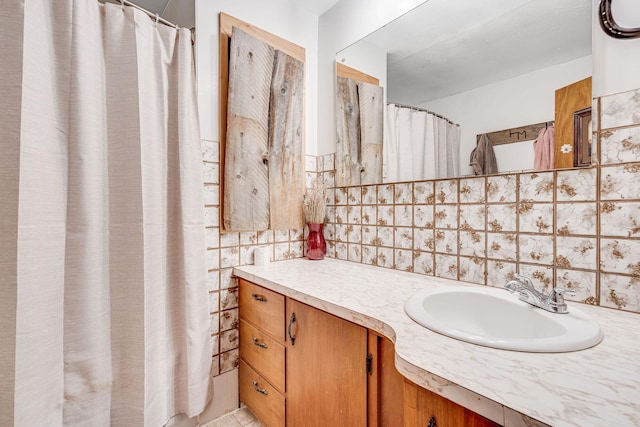 bathroom featuring vanity and decorative backsplash