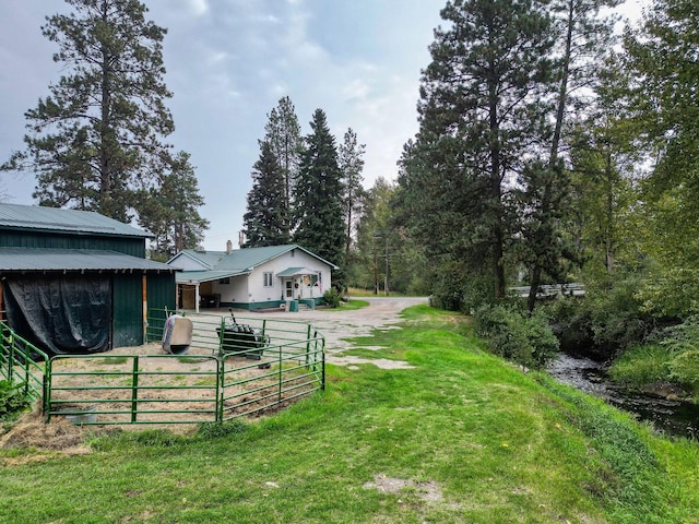 view of yard with dirt driveway