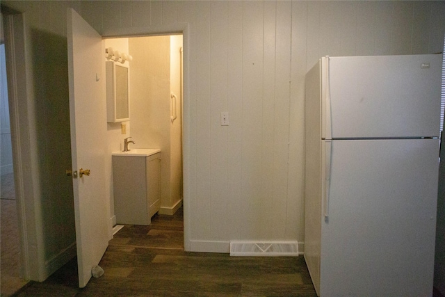 interior space with visible vents, wood finished floors, and vanity