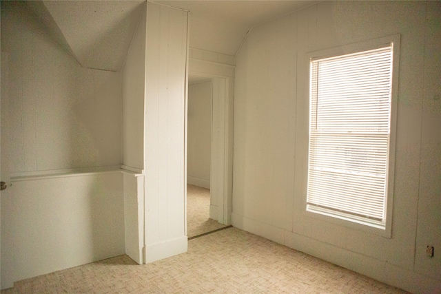 interior space featuring carpet floors and lofted ceiling