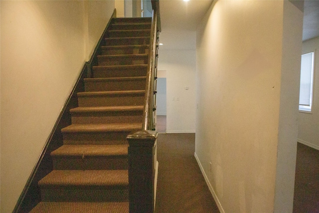 staircase featuring baseboards