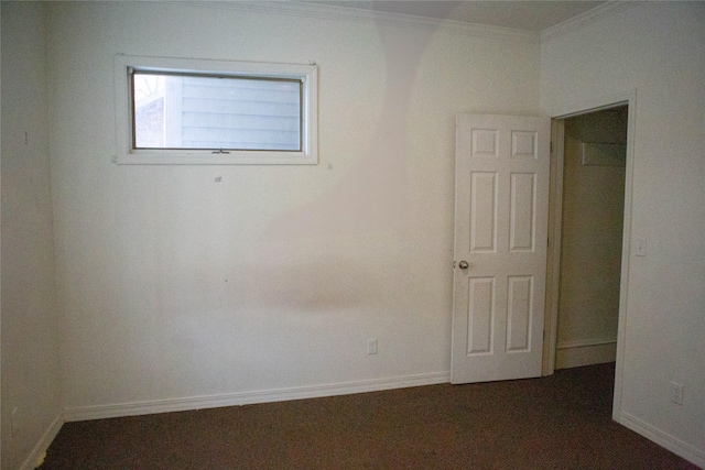 unfurnished room with baseboards and crown molding