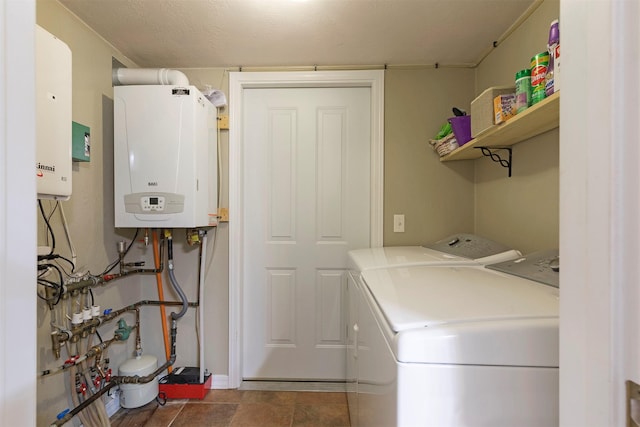 washroom with washing machine and dryer, laundry area, and water heater