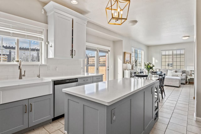 5331 Fiddler Ct, Florence, MT 59833 - kitchen with stainless steel dishwasher, gray cabinets, light tile patterned floors, and a center island