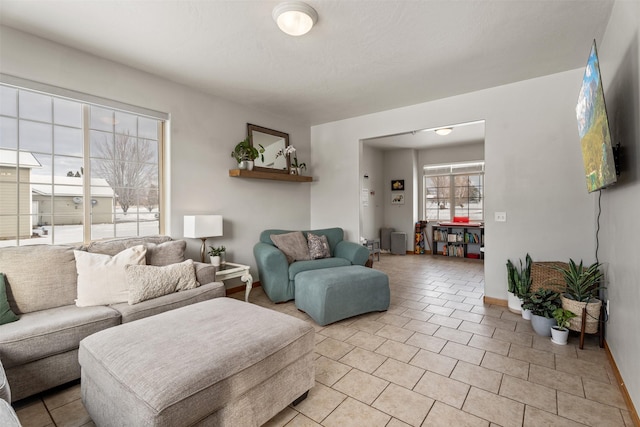 living room featuring baseboards and light tile patterned flooring