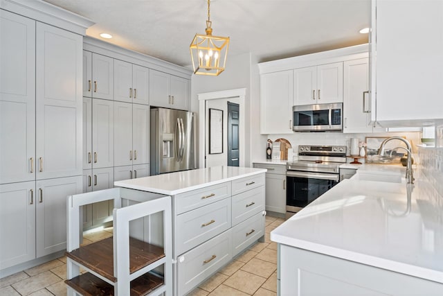 kitchen featuring light tile patterned floors, tasteful backsplash, stainless steel appliances, light countertops, and a sink