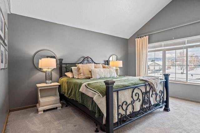 bedroom featuring carpet floors, lofted ceiling, and baseboards