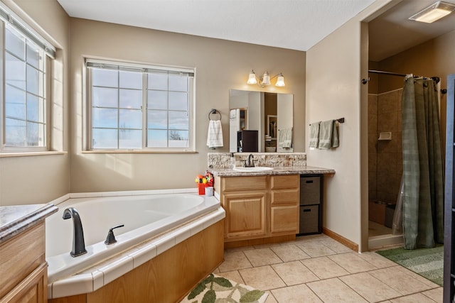 5331 Fiddler Ct, Florence, MT 59833 - full bathroom featuring a stall shower, a garden tub, vanity, and tile patterned flooring