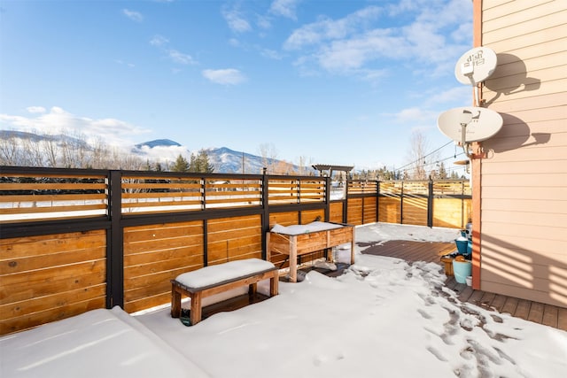 snow covered patio with a mountain view