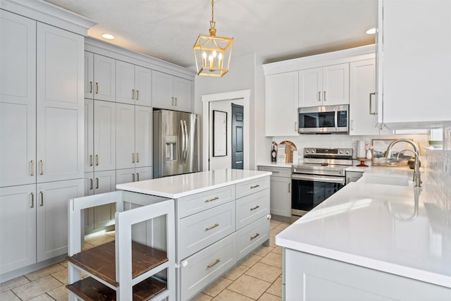 5331 Fiddler Ct, Florence, MT 59833 - kitchen featuring appliances with stainless steel finishes, a sink, light countertops, tasteful backsplash, and a chandelier