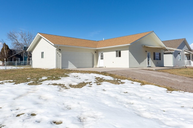 view of front facade with a garage and fence