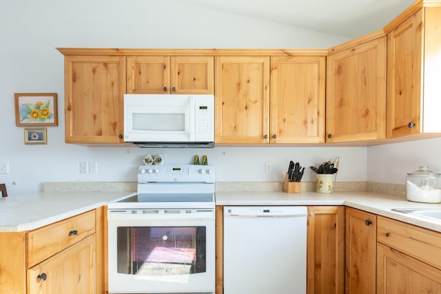 kitchen with lofted ceiling, white appliances, and light brown cabinetry