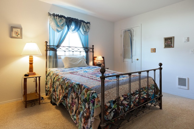 bedroom with carpet, heating unit, and baseboards