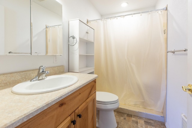 full bath featuring toilet, curtained shower, and vanity