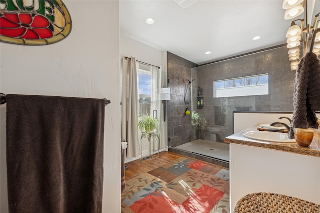 full bath with wood finished floors, walk in shower, vanity, and recessed lighting