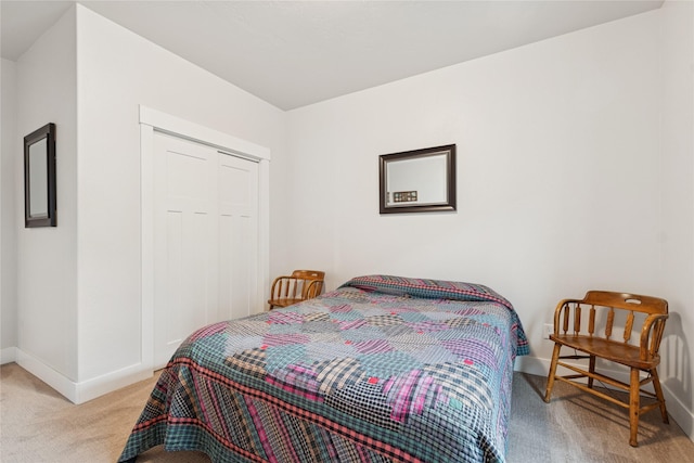 bedroom with light carpet and baseboards