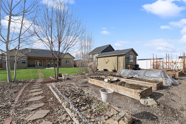 view of yard featuring a garden and an outdoor structure