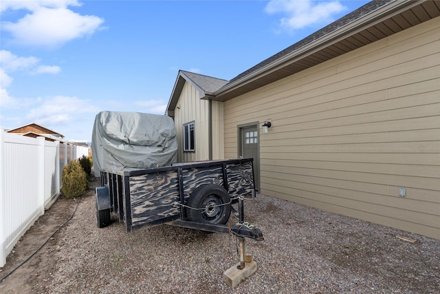 view of side of home featuring fence