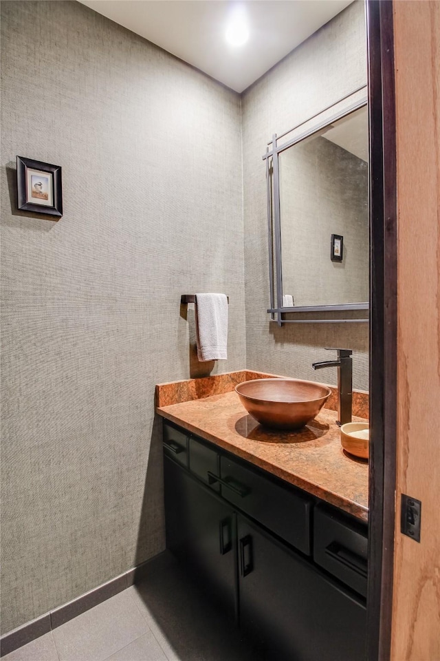 bathroom with double vanity, a sink, and tile patterned floors