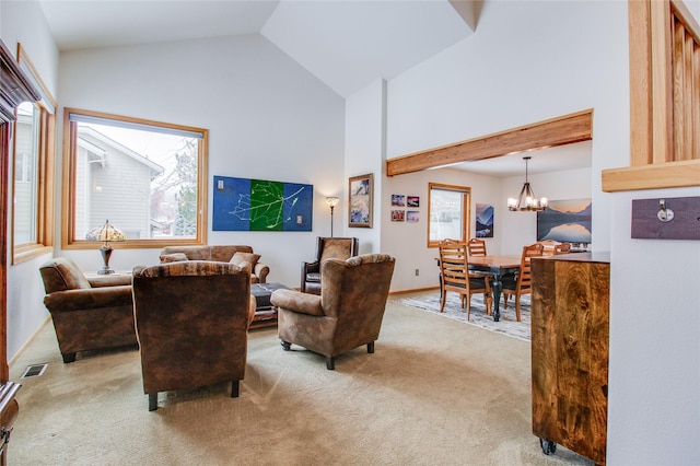 living room with high vaulted ceiling, a notable chandelier, light colored carpet, visible vents, and baseboards