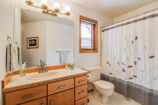 bathroom featuring a shower with curtain, vanity, toilet, and tile patterned floors