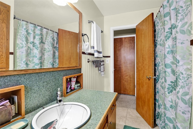 bathroom with a shower with curtain, tile patterned floors, and vanity