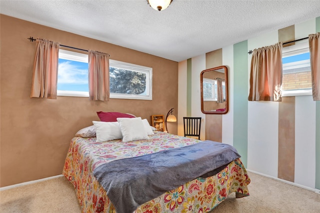 carpeted bedroom with a textured ceiling and baseboards