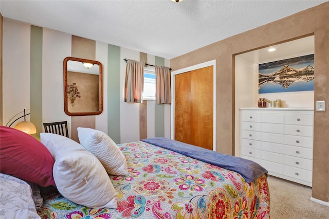 bedroom with carpet, a closet, and a textured ceiling