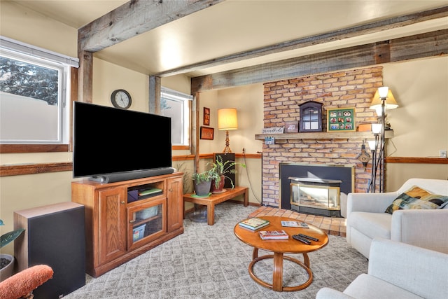 living area with beam ceiling, wainscoting, a fireplace, and carpet flooring