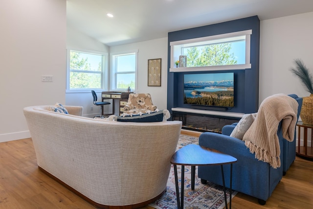 living area with vaulted ceiling, recessed lighting, baseboards, and wood finished floors