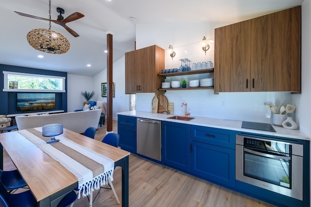 kitchen featuring a sink, open shelves, stainless steel appliances, light countertops, and vaulted ceiling