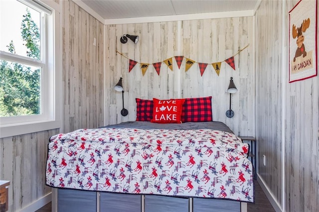 bedroom featuring wood walls