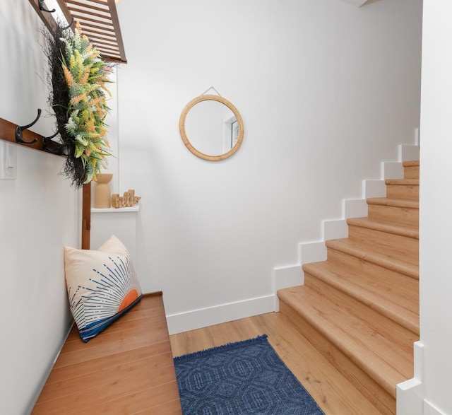 interior space featuring stairway, baseboards, and wood finished floors