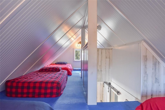 carpeted bedroom with lofted ceiling