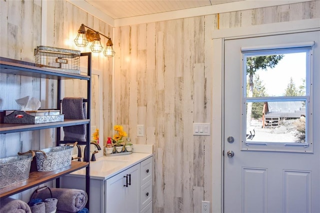 doorway with wood walls and a sink