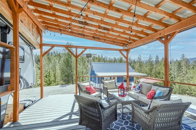 wooden deck with an outdoor living space and an outdoor structure