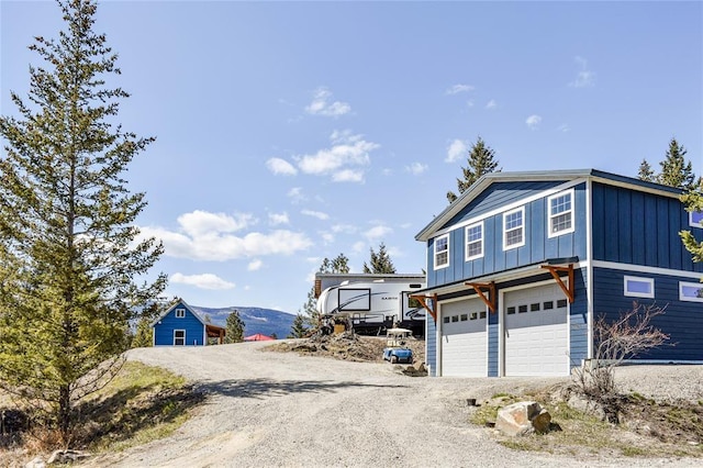 exterior space with an attached garage, board and batten siding, and driveway