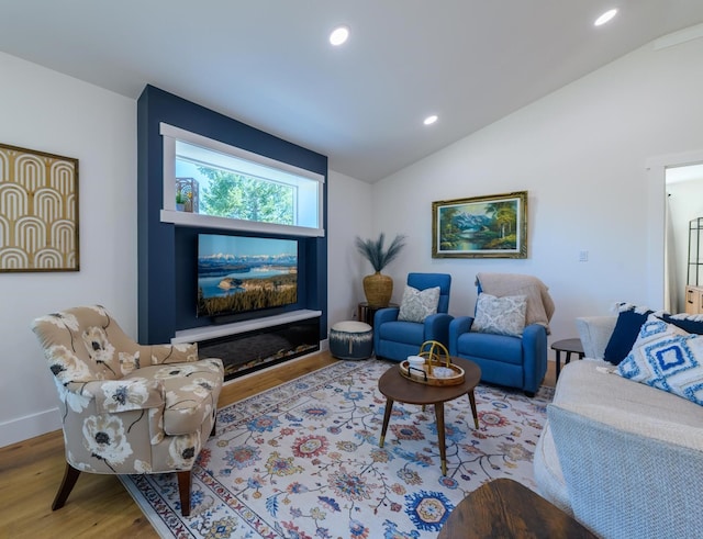 living room with recessed lighting, wood finished floors, baseboards, and vaulted ceiling