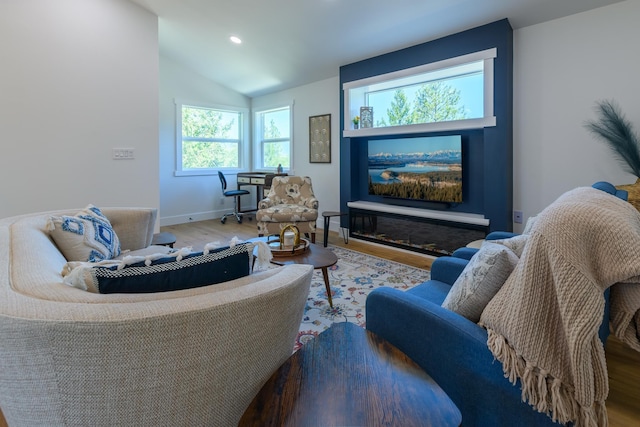 living area with recessed lighting, baseboards, lofted ceiling, and wood finished floors