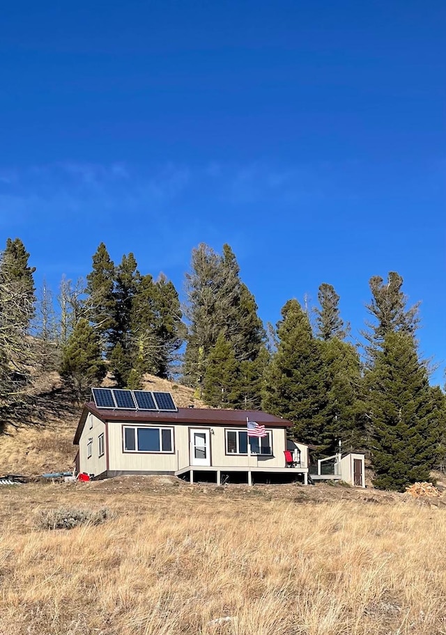 view of front facade with roof mounted solar panels